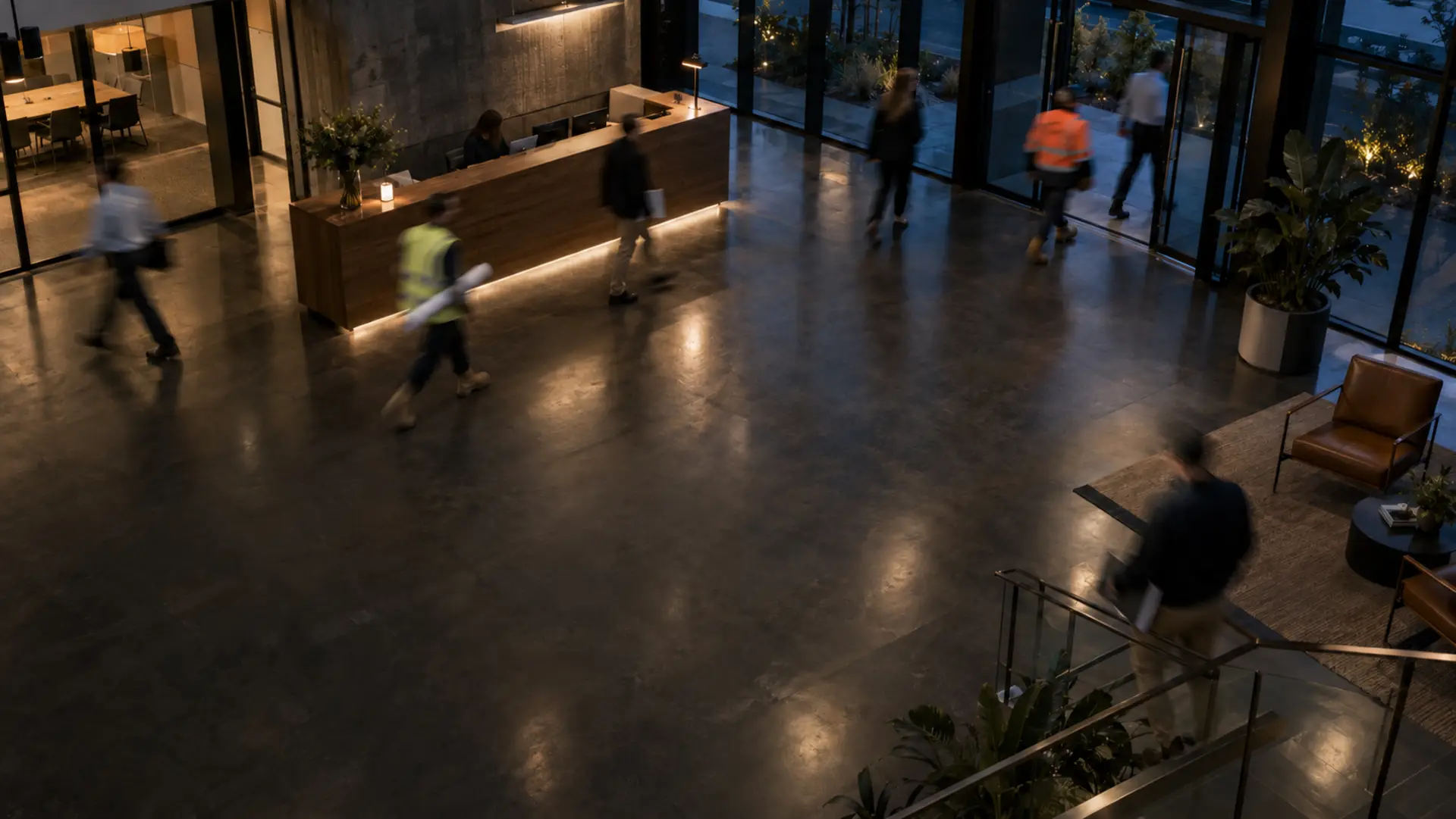 People crossing a contractor's office foyer in the evening